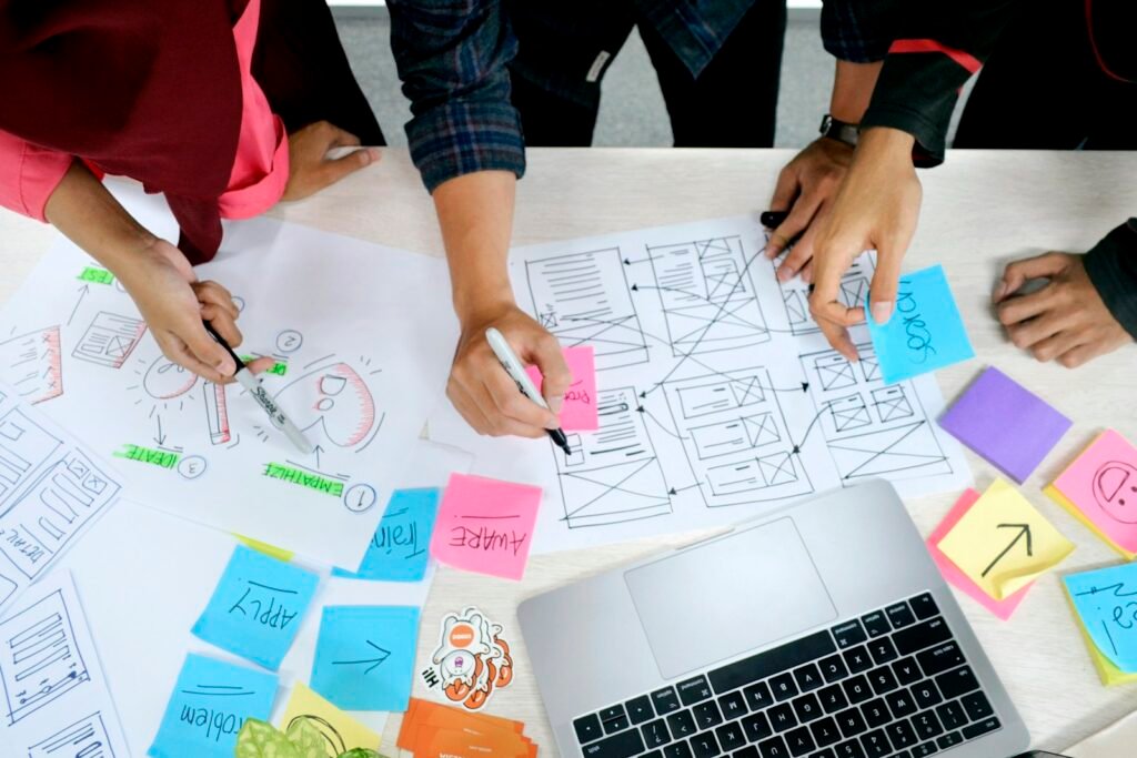 Designer sketching website wireframes on paper