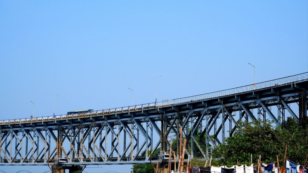 A train crossing a long bridge over a wide river