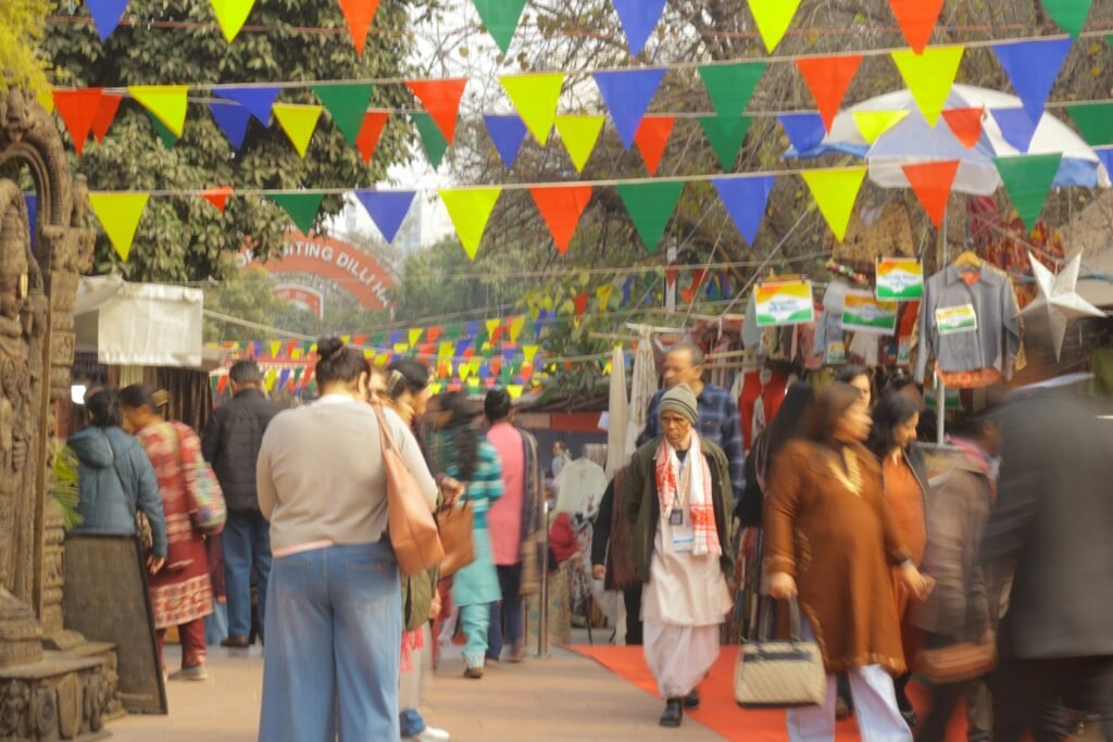 People browsing stalls at a colourful outdoor market