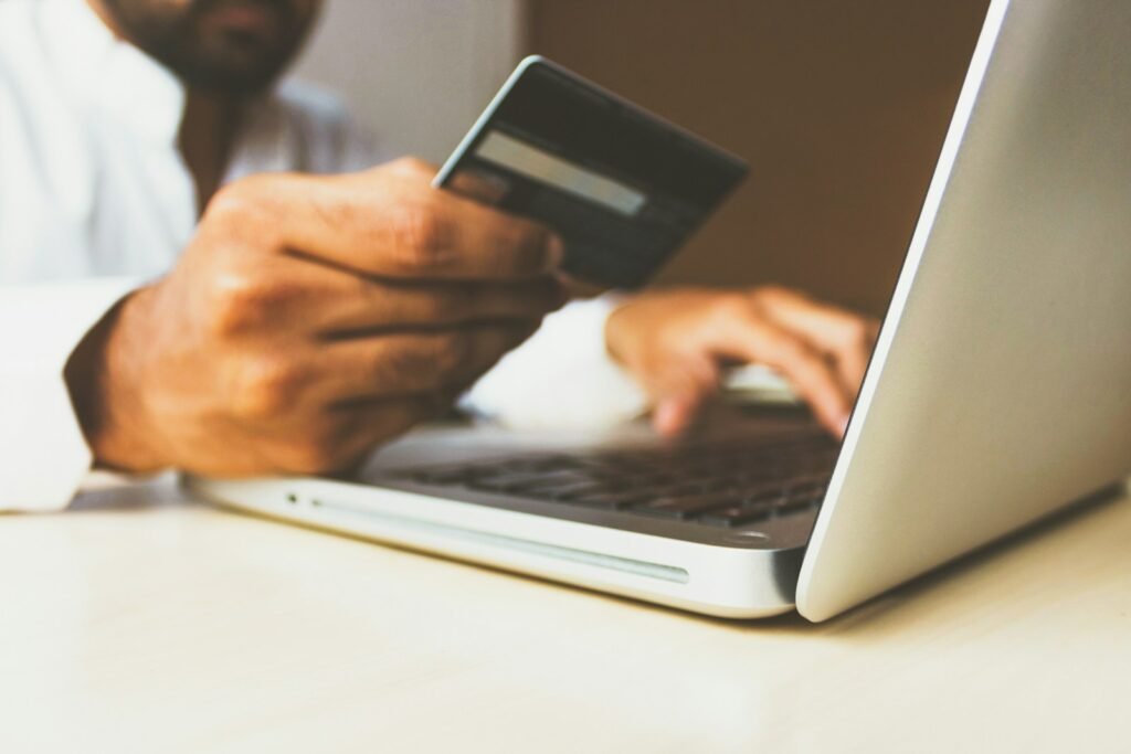 Online store order being packed next to a laptop