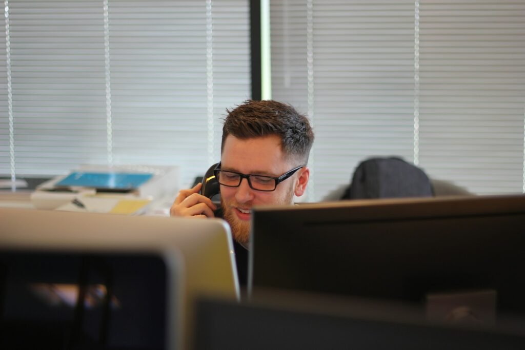 Business owner taking a customer call at a desk