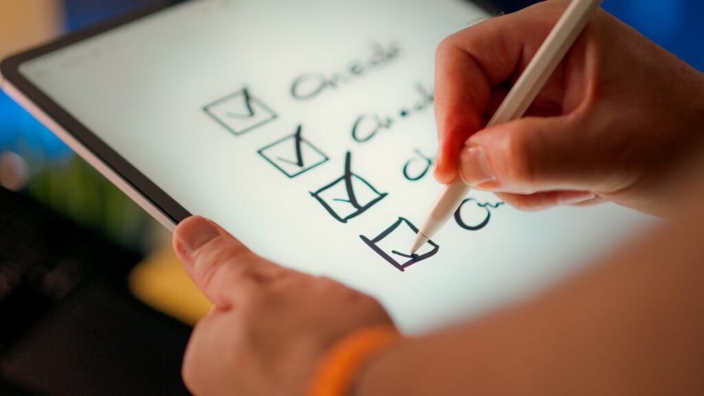 Hand ticking items on a checklist