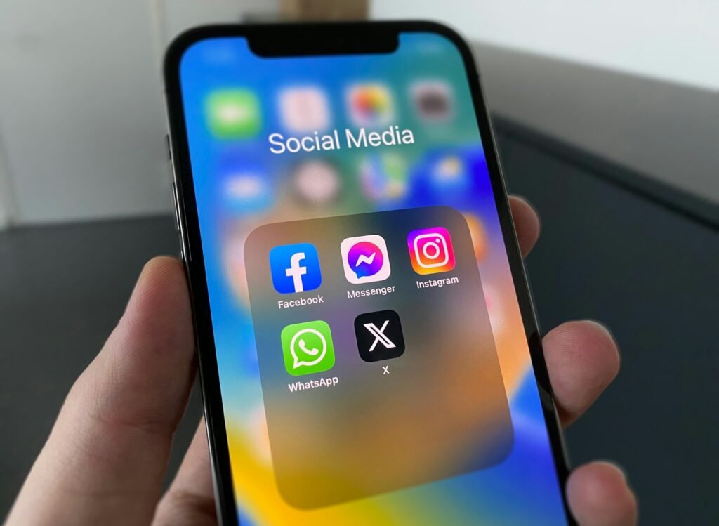 A person holding a phone with a social media feed on the screen