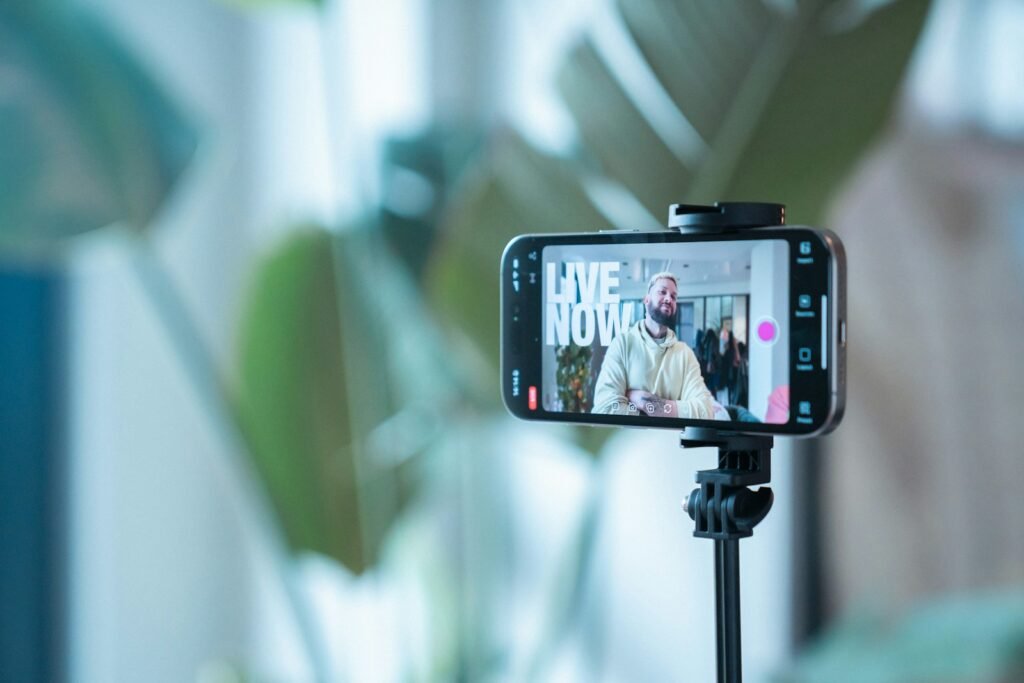 Smartphone on a stand recording a man speaking to camera